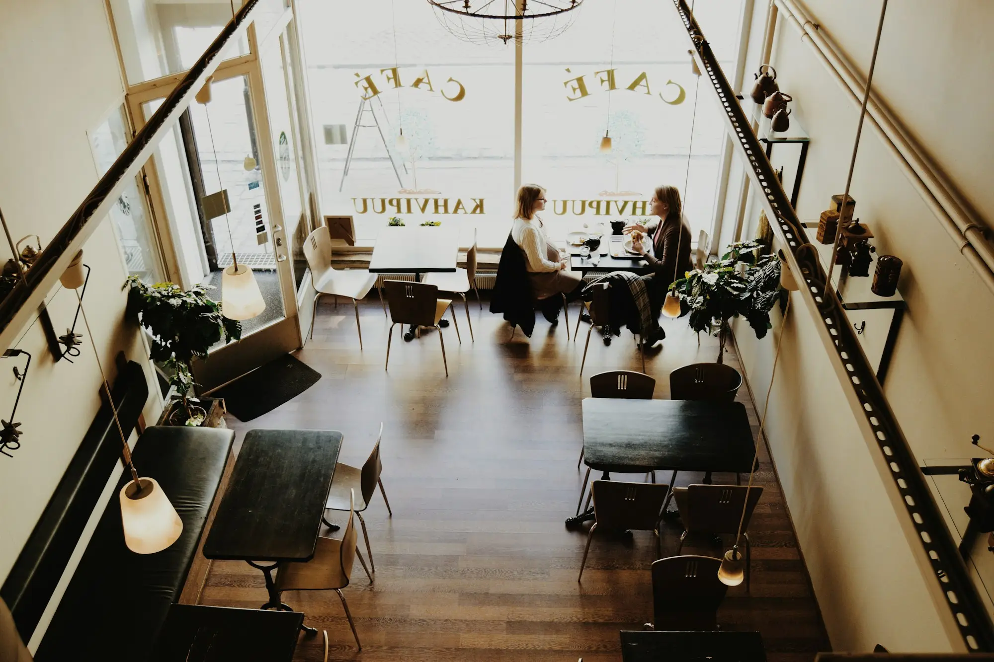 Two people talking at a café table