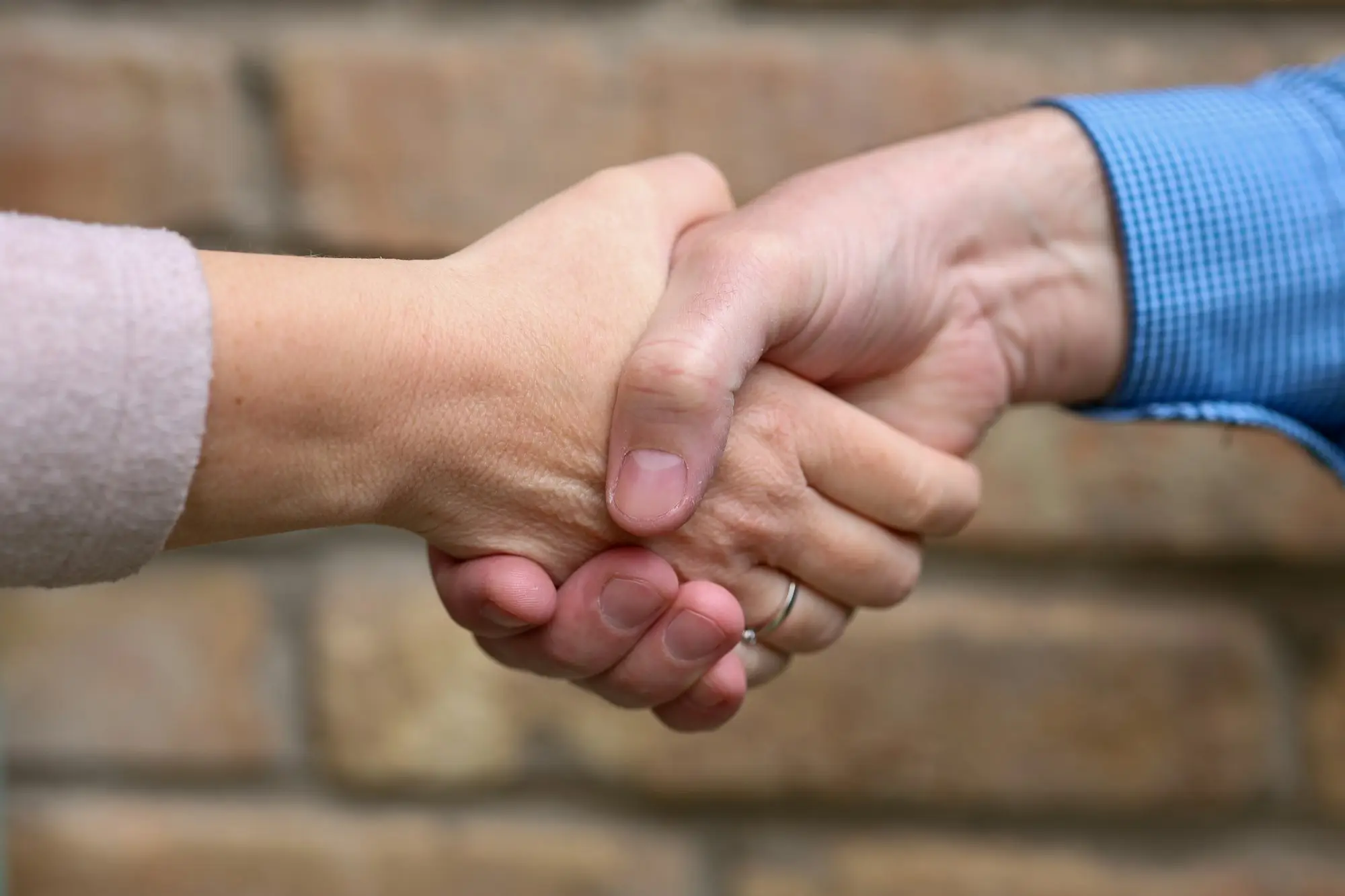 Two people shaking hands on a business deal
