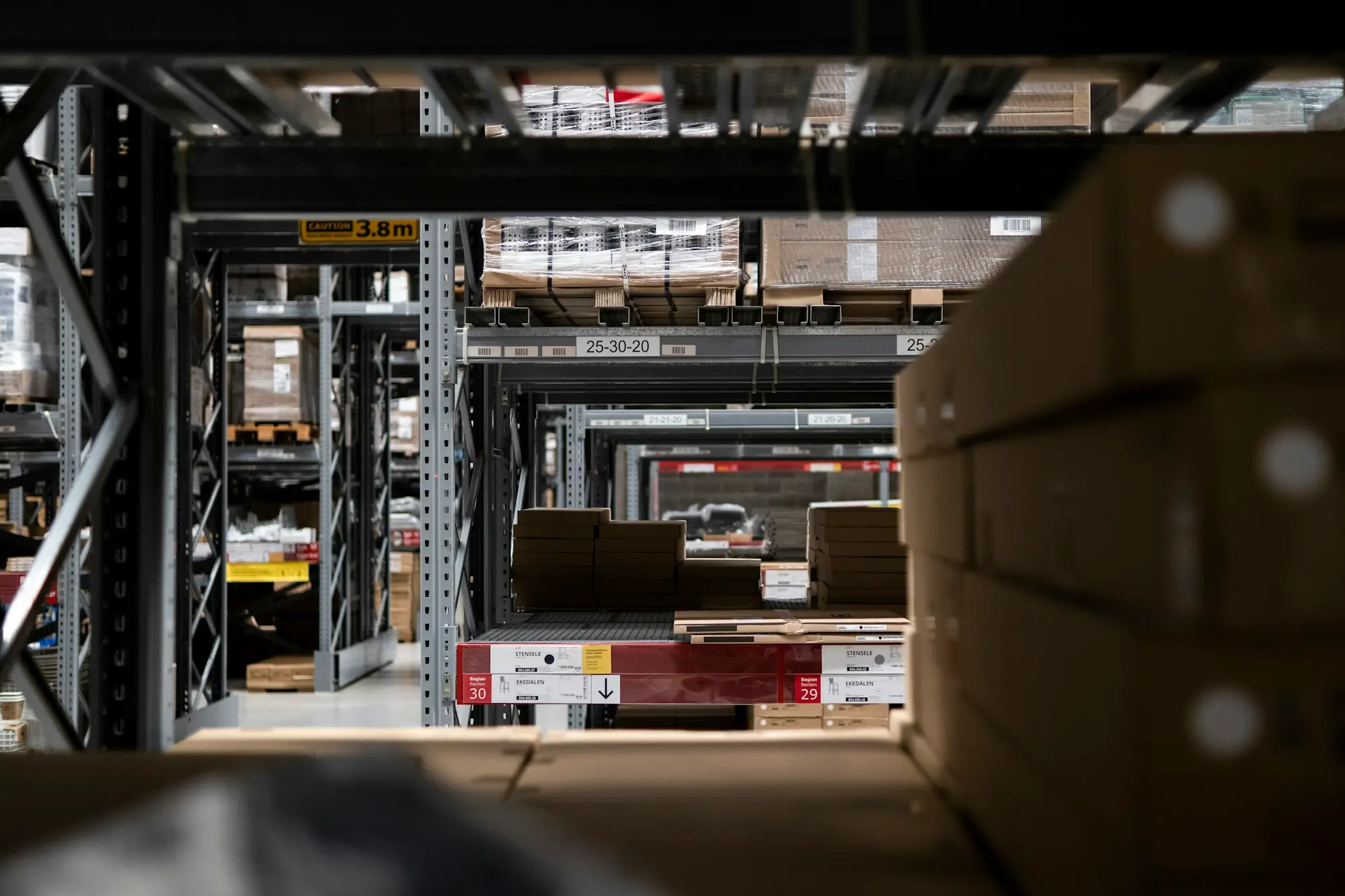 Warehouse shelves stacked with boxed orders